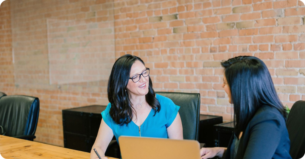 Two happy workers talking with each other